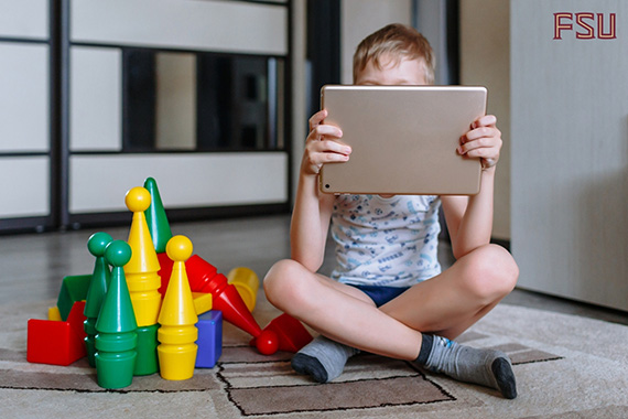 Child sitting next to blocks